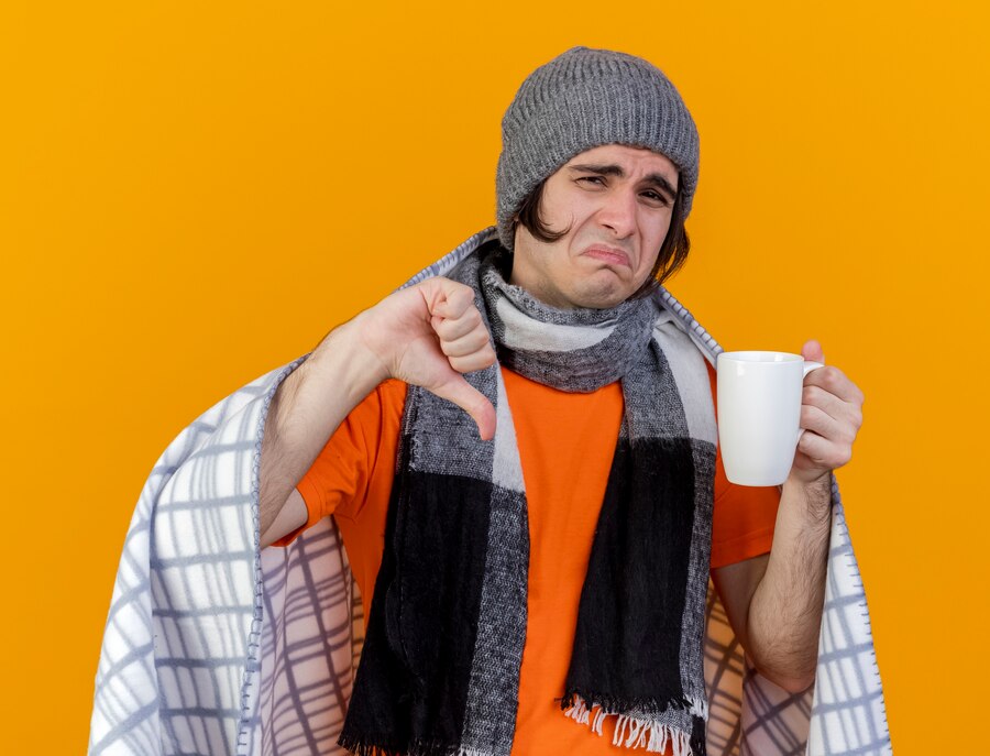 unpleased-young-ill-man-wearing-winter-hat-with-scarf